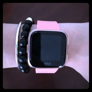 Pink Fitbit Versa 2 with small default wrist band